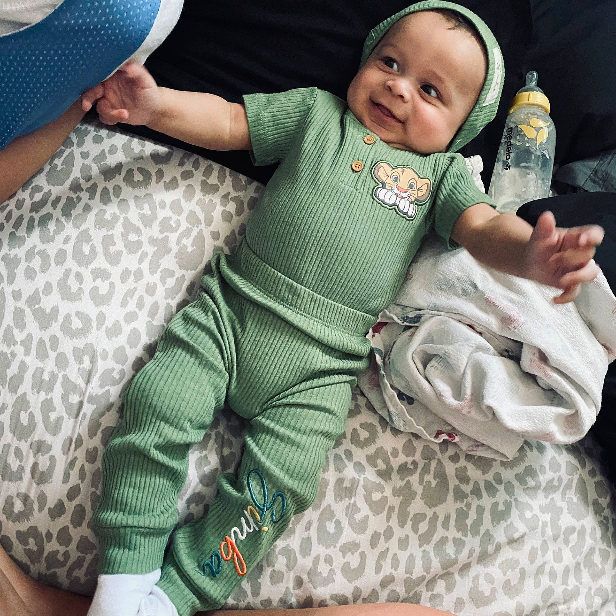 Kane joined the competition — help win amazing prizes! baby, baby_products, baby_safety, baby_toddler_clothing, cap, child, comfort, fashion_accessory, grass, happy, joy, lap, leg, linens, pattern, person, sitting, sleeve, smile, textile