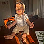Daniel joined the competition — help win amazing prizes! baby, barefoot, blue_eyes, child, curly_hair, expression, hat, home, indoor, person, portrait, shadow, shorts, sitting, striped_shirt, sunlight, table, toddler, warm_light, wood