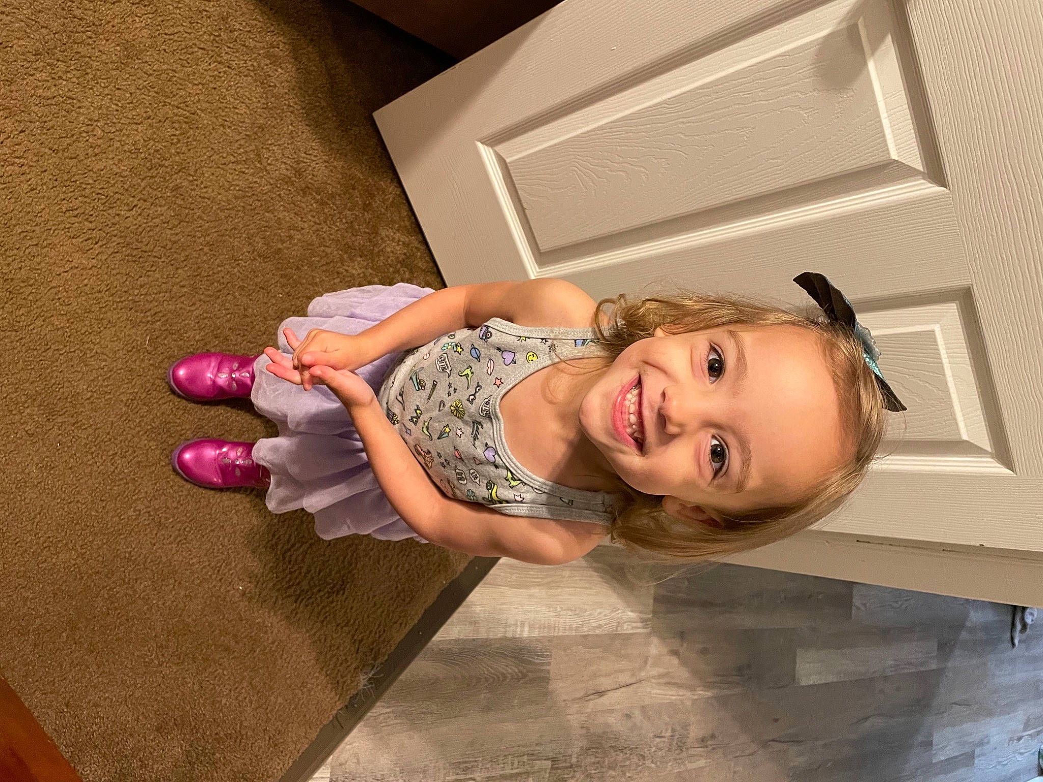 Masie is registered to the contest to win money with this photo: baby_toddler_clothing, child, dress, eye, floor, flooring, fun, happy, hardwood, house, human_body, human_leg, joy, person, room, shoulder, skin, smile, toddler, toy