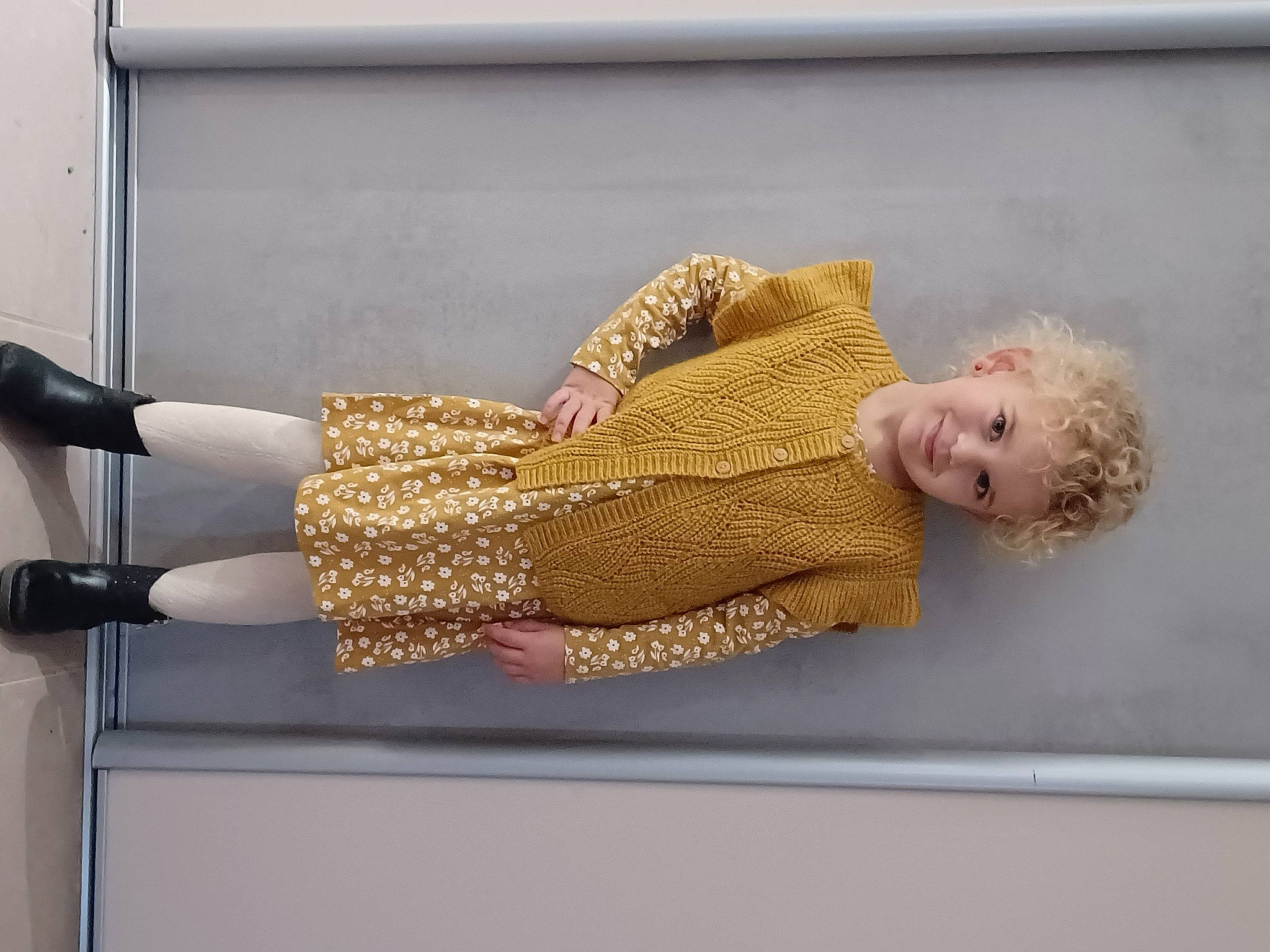 Inaya participe au concours pour gagner de l'argent avec cette photo : baby_toddler_clothing, cocktail_dress, comfort, elbow, flooring, human_leg, joy, knee, magenta, pattern, person, rectangle, room, sitting, sleeve, thigh, toddler, waist, wood, wrist