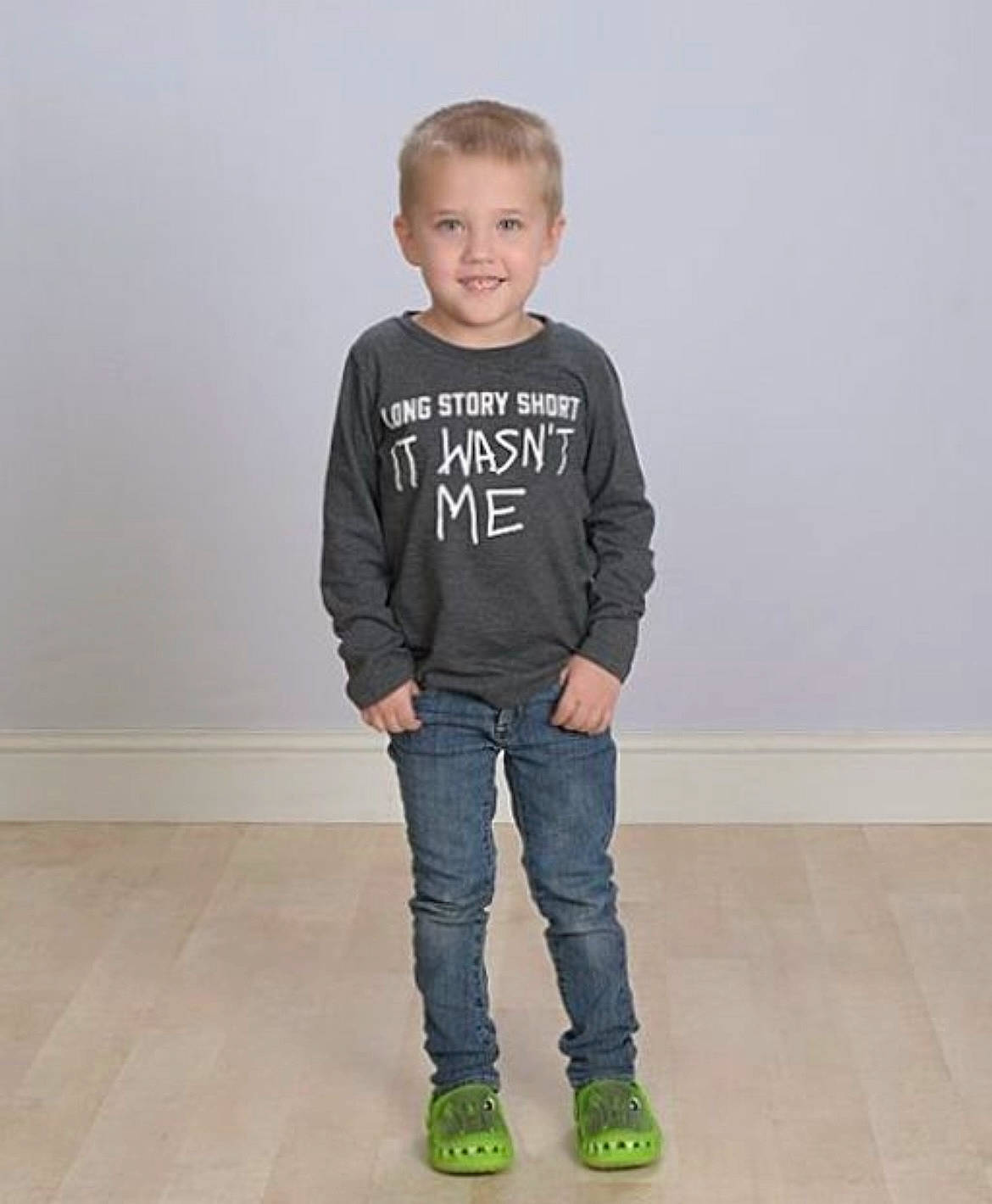 Kayleb is registered to the contest to win money with this photo: arm, denim, face, fashion_design, flash_photography, floor, flooring, footwear, grey, hair, head, human_body, jeans, joy, leg, neck, person, shoulder, sleeve, smile