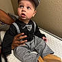 baby, child, infant, hat, bow_tie, black_shirt, houndstooth, pants, shoes, brown_shoes, changing_pad, hand, support, indoors, wall, portrait, cute, looking_up, fashion, person