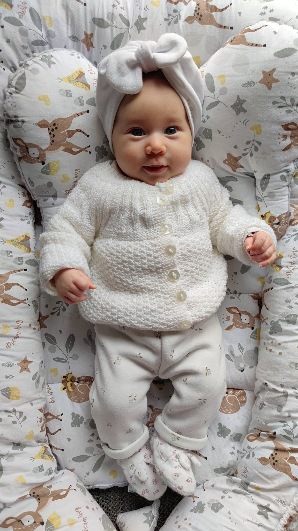 Isobel participe au concours pour gagner de l'argent avec cette photo : baby, baby_toddler_clothing, cheek, child, comfort, eye, face, fashion_accessory, happy, head, headwear, iris, linens, pattern, person, product, skin, sleeve, smile, textile