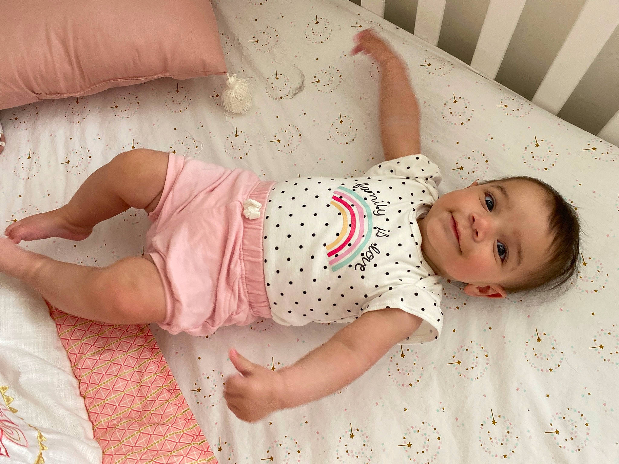 Raya is registered to the contest to win money with this photo: arm, baby, baby_toddler_clothing, child, comfort, dress, eye, finger, glasses, hand, happy, head, human, human_body, joy, person, pink, skin, sleeve, smile