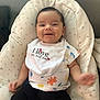 Pablo participe au concours pour gagner de l'argent avec cette photo : baby, bib, black_pants, chair, child, clothing, comfort, crab, cushion, cute, face, happy, indoors, infant, person, shirt, sitting, smiling, star_pattern, young_child