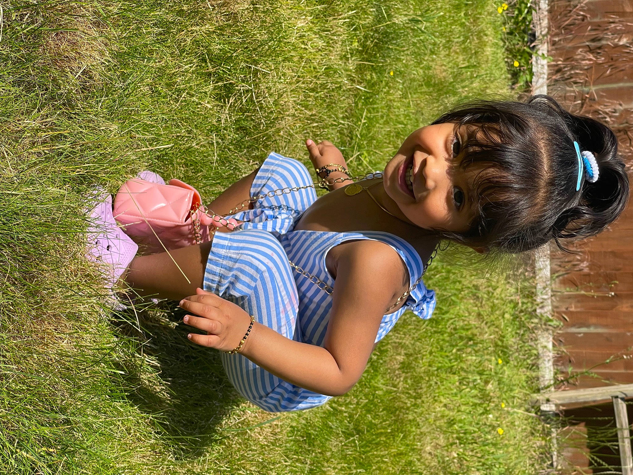 Iniya is registered to the contest to win money with this photo: arm, child, fun, grass, grass_family, grassland, happy, human_body, joint, joy, leisure, meadow, people_in_nature, person, plant, recreation, smile, summer, sunlight, thigh