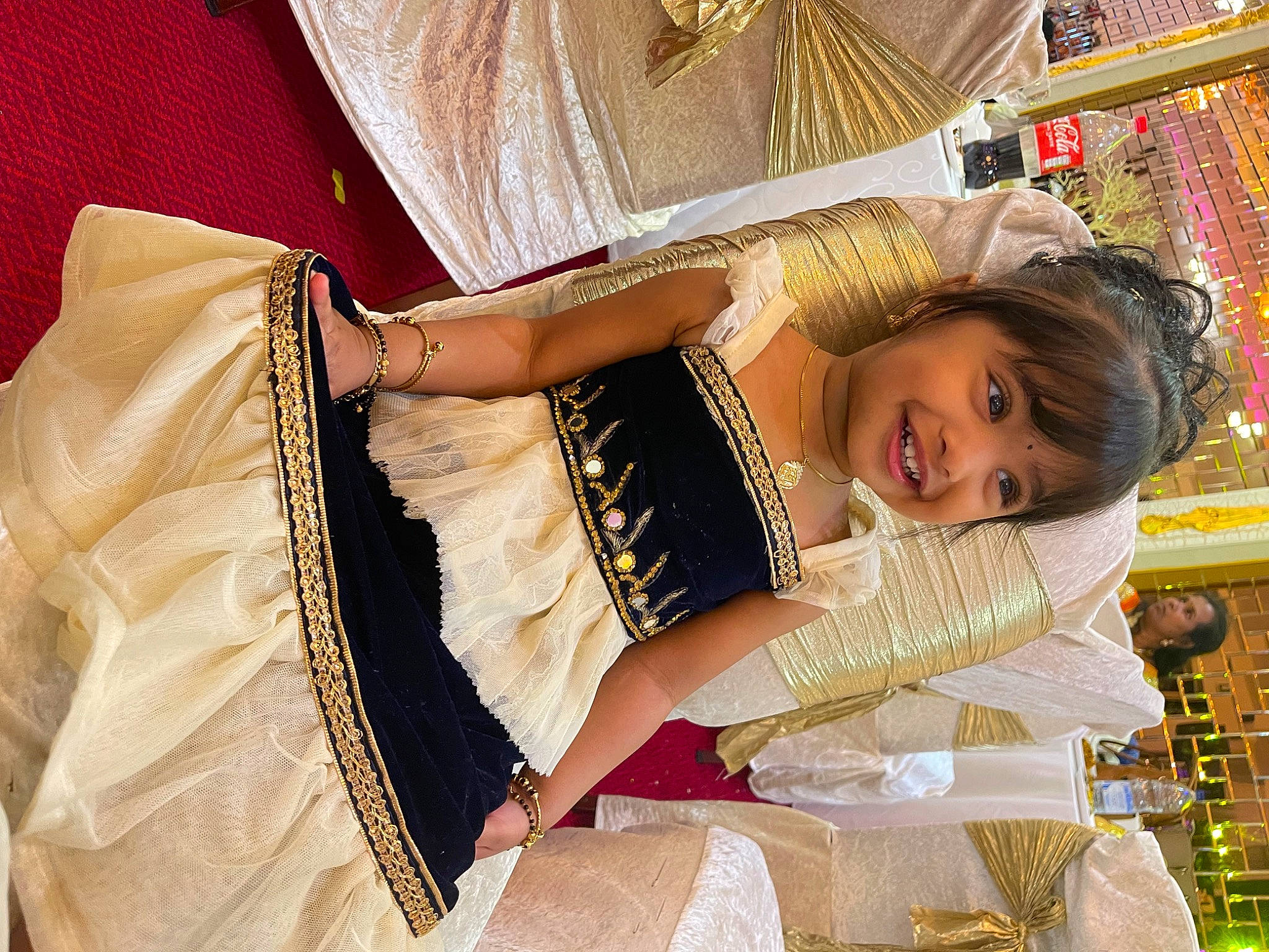 Iniya is registered to the contest to win money with this photo: abdomen, child, fashion_accessory, fashion_design, formal_wear, fun, happy, human_leg, jewellery, joy, pattern, peach, person, sari, skin, sleeve, smile, thigh, tradition, trunk