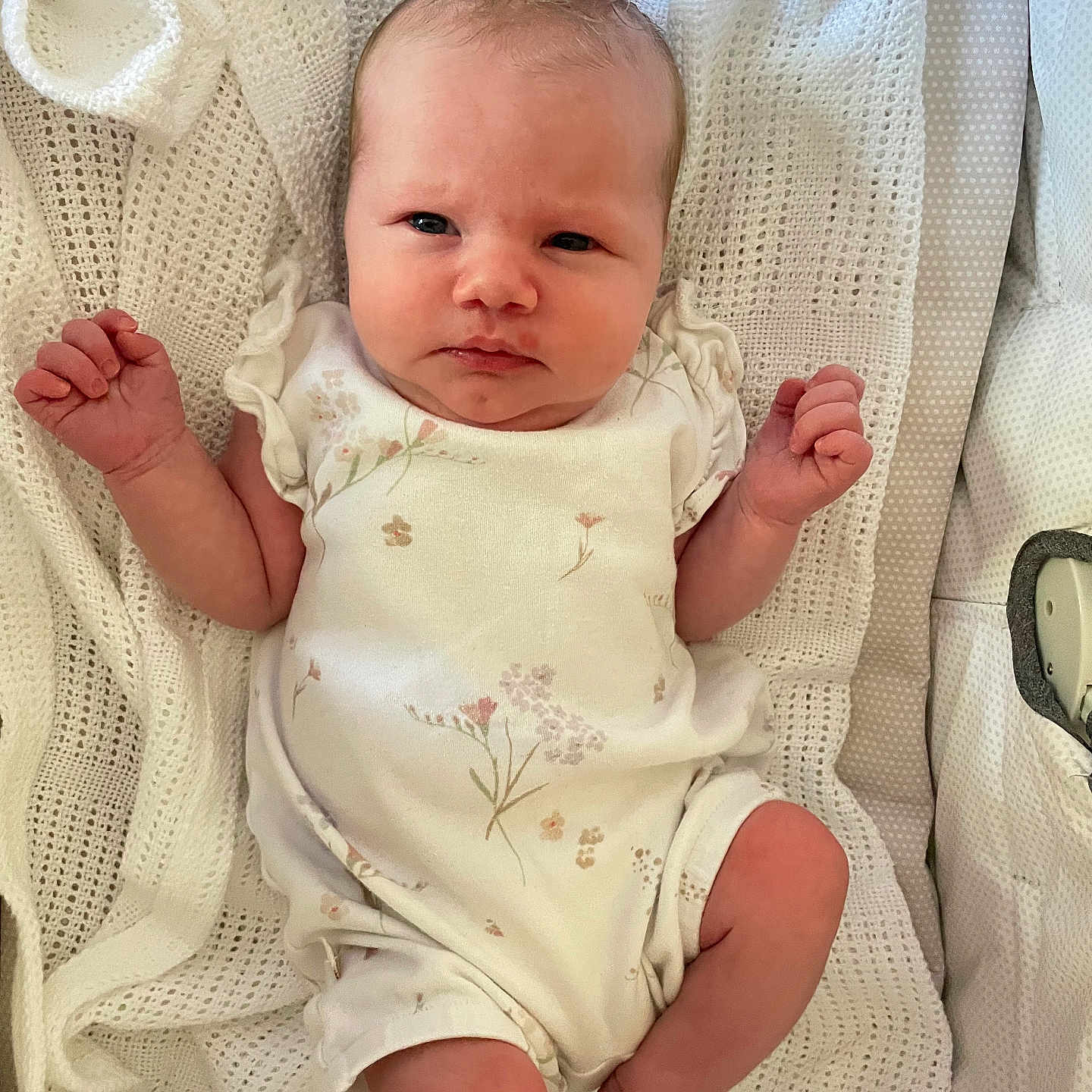 órla Rowan Fay is registered to the contest to win money with this photo: baby, blanket, child, cozy, cute, face, floral, hand, indoors, infant, knitted, leg, newborn, onesie, person, resting, skin, sleepwear, soft, white