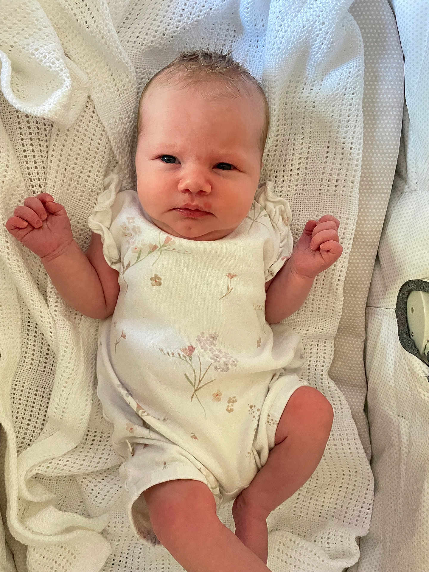 órla Rowan Fay is registered to the contest to win money with this photo: baby, infant, blanket, knitted, white, onesie, floral, cute, newborn, person, skin, face, hand, leg, sleepwear, indoors, child, resting, soft, cozy