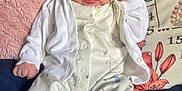 órla Rowan Fay joined the competition — help win amazing prizes! baby, infant, bed, pillow, clothing, cardigan, white, soft, cute, face, legs, socks, bunny_pattern, hand, blue_eyes, blanket, floral, comfort, indoor, portrait