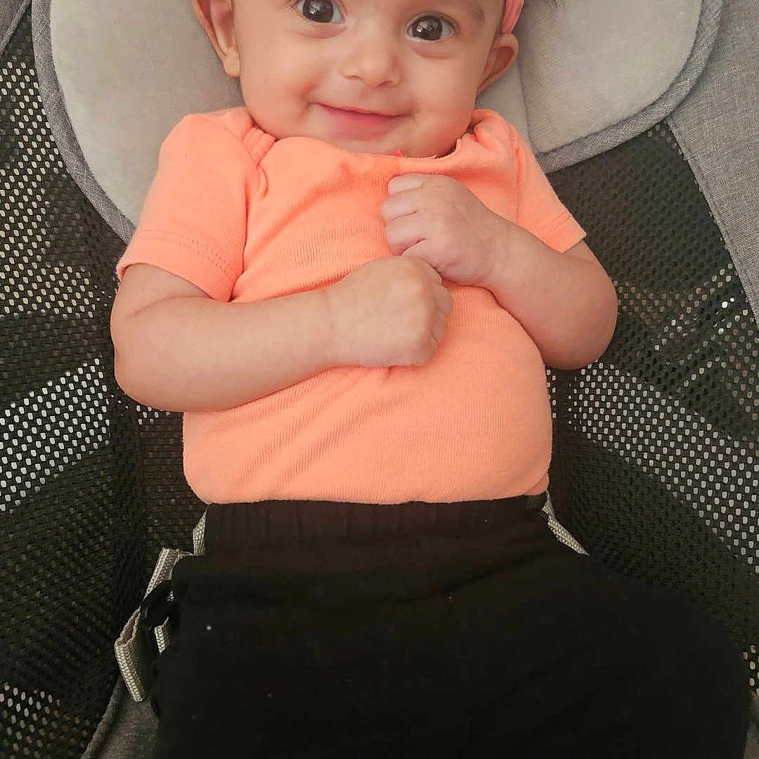 Aurora joined the competition — help win amazing prizes! baby, baby_clothing, baby_seat, big_eyes, black_pants, chair, child, closeup, cute, happy, headband, indoor, infant, orange_shirt, peach, portrait, seated, small_hands, smiling, soft_fabric