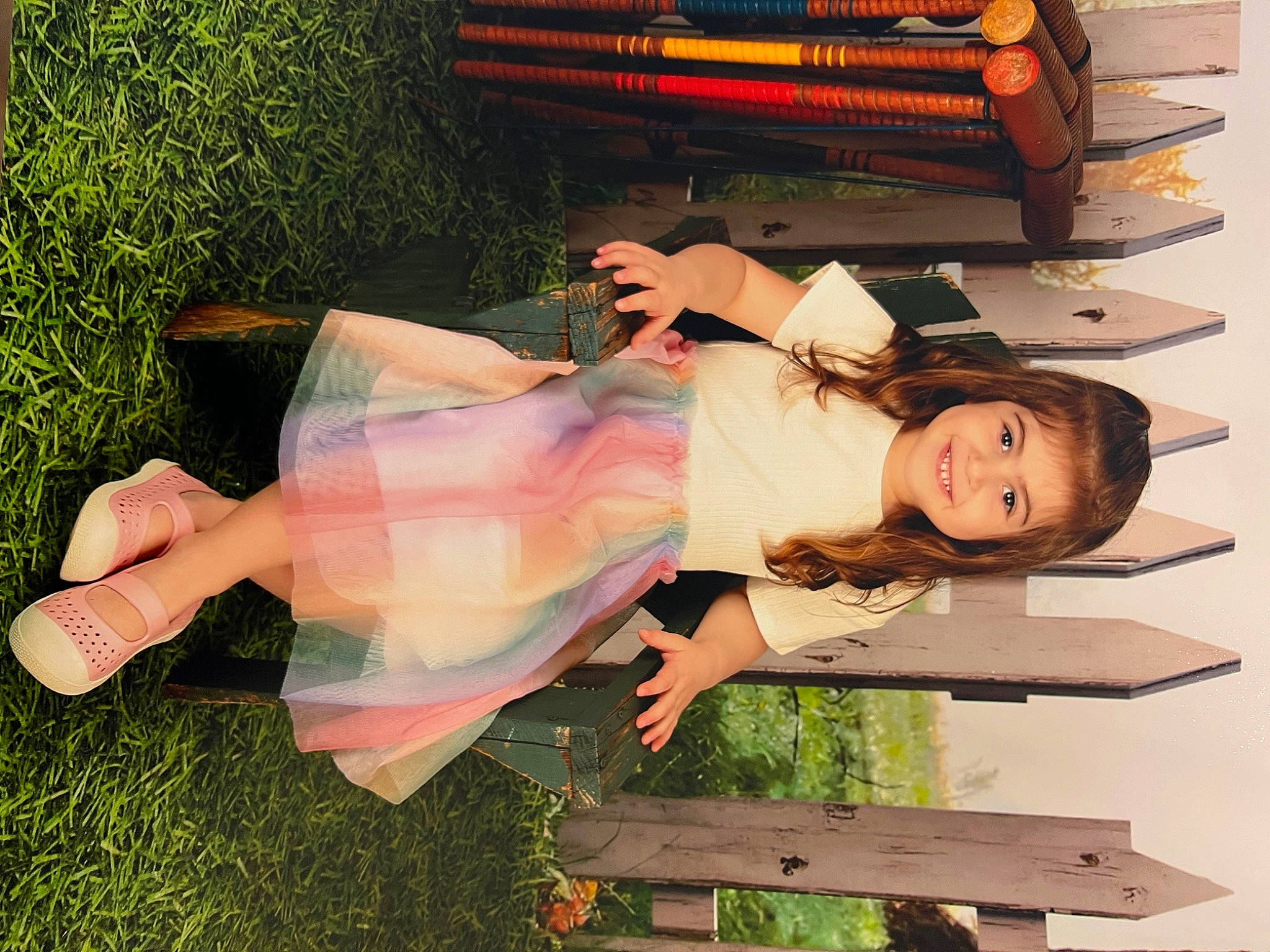 Addison joined the competition — help win amazing prizes! book, child, dress, fun, grass, happy, human_leg, joy, leisure, office_equipment, office_supplies, people_in_nature, person, plant, sandal, sitting, smile, thigh, wood, writing_implement