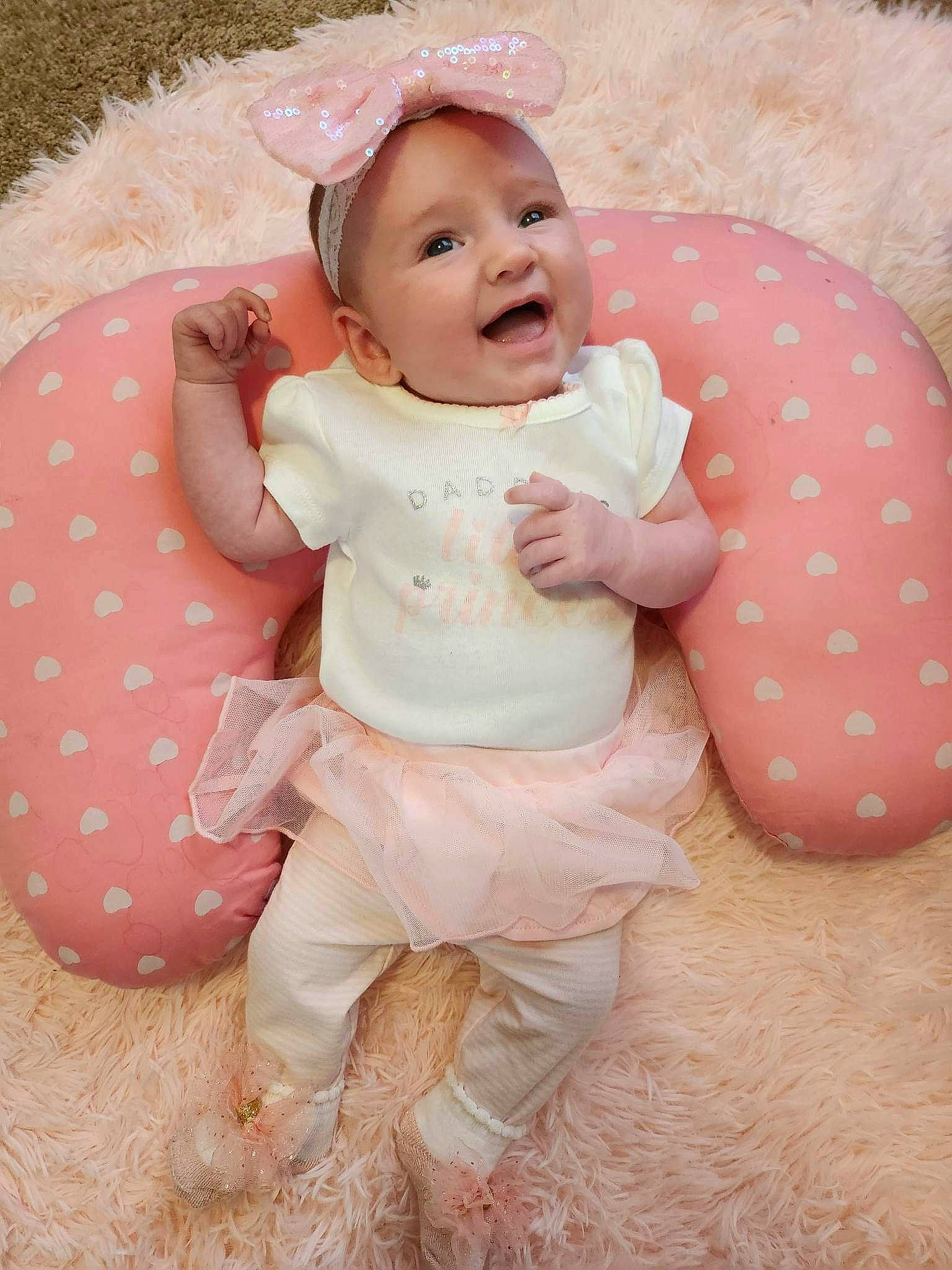 Olivia Rae is registered to the contest to win money with this photo: baby, baby_toddler_clothing, cheek, child, comfort, face, fun, grass, happy, hat, linens, pattern, person, pink, sitting, skin, sleeve, smile, sun_hat, textile