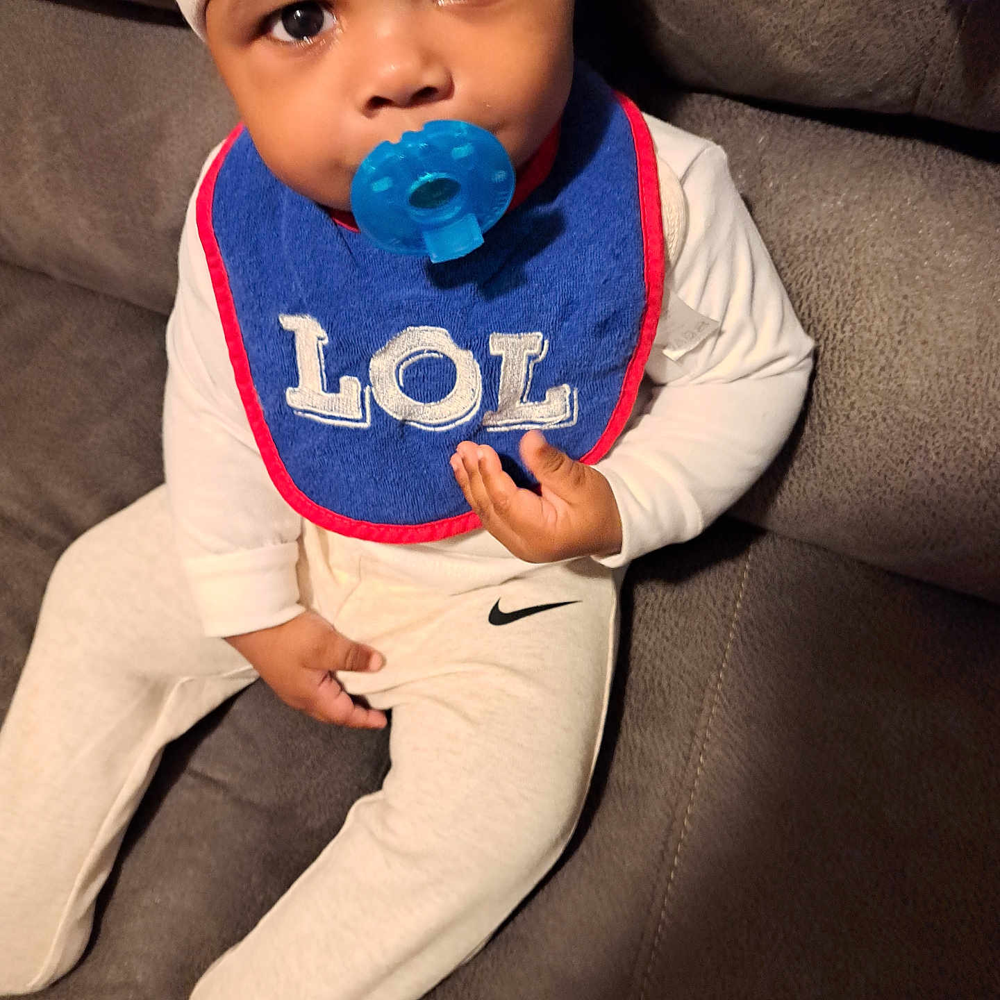 Ja'Hari joined the competition — help win amazing prizes! baby, baseballcap, bib, bodypart, bonnet, cap, clothing, couch, cushion, face, finger, furniture, hand, hat, head, homedecor, person, photography, portrait, sitting