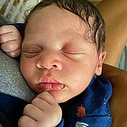 Roman is registered to the contest to win money with this photo: baby, newborn, sleeping, face, hand, clothing, infant, peaceful, skin, person, closeup, cute, resting, portrait, young, child, fingers, tiny, warm, cozy