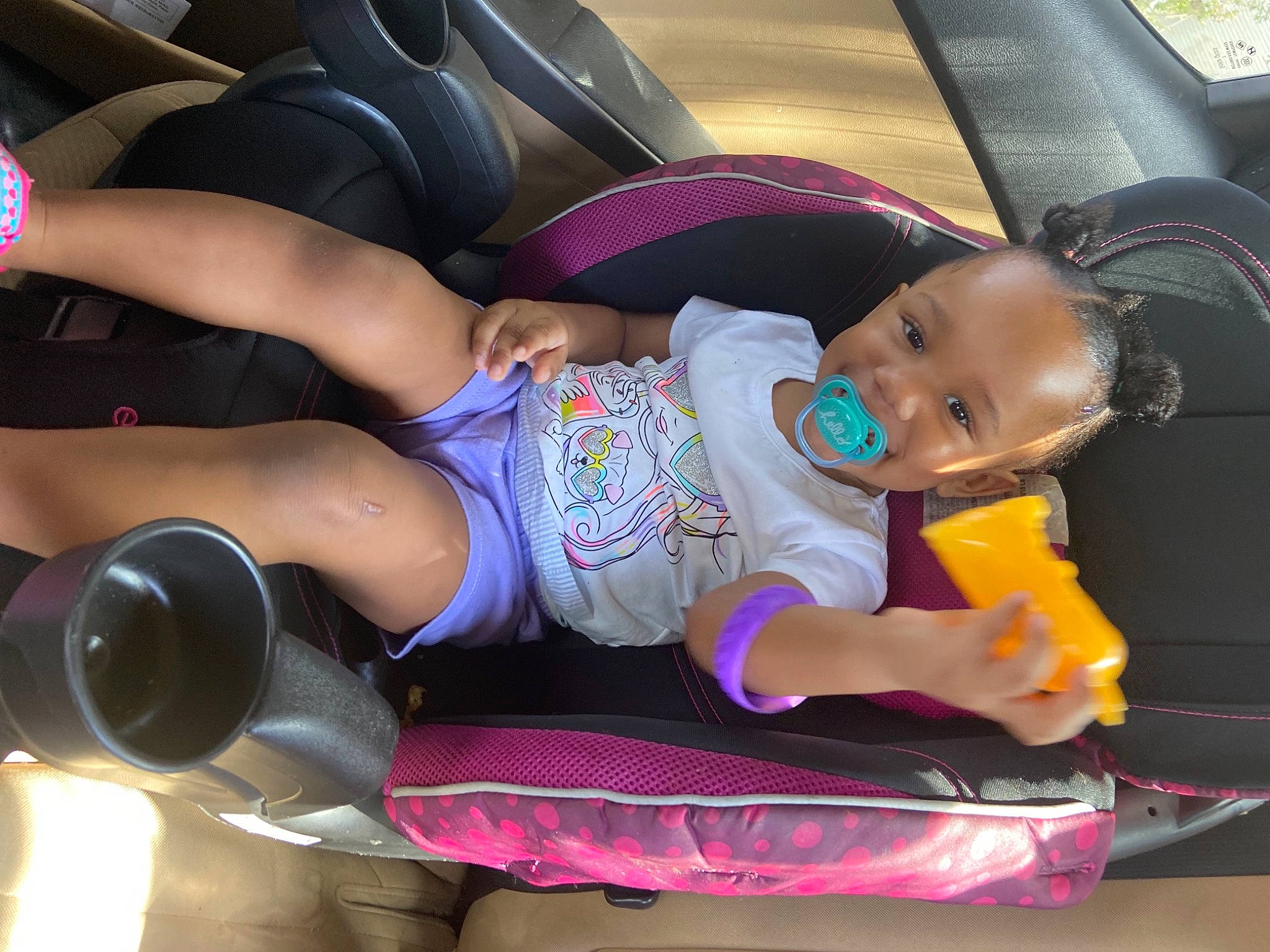 Lauryn is registered to the contest to win money with this photo: auto_part, automotive_design, baby, baby_carriage, baby_products, baby_toddler_clothing, car_seat, car_seat_cover, child, comfort, fun, joy, mode_of_transport, motor_vehicle, person, shorts, steering_wheel, thigh, tire, toddler