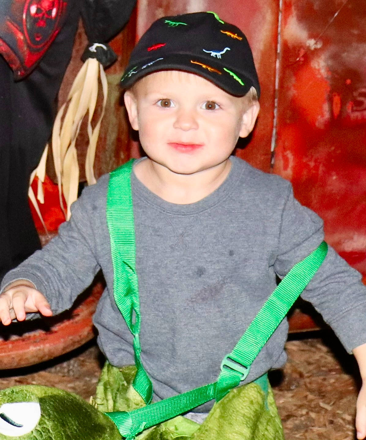 Wesson is registered to the contest to win money with this photo: baseball_cap, cap, child, costume_hat, event, facial_expression, fun, grass, green, happy, headgear, headwear, holiday, human, outerwear, person, product, sleeve, smile, t_shirt