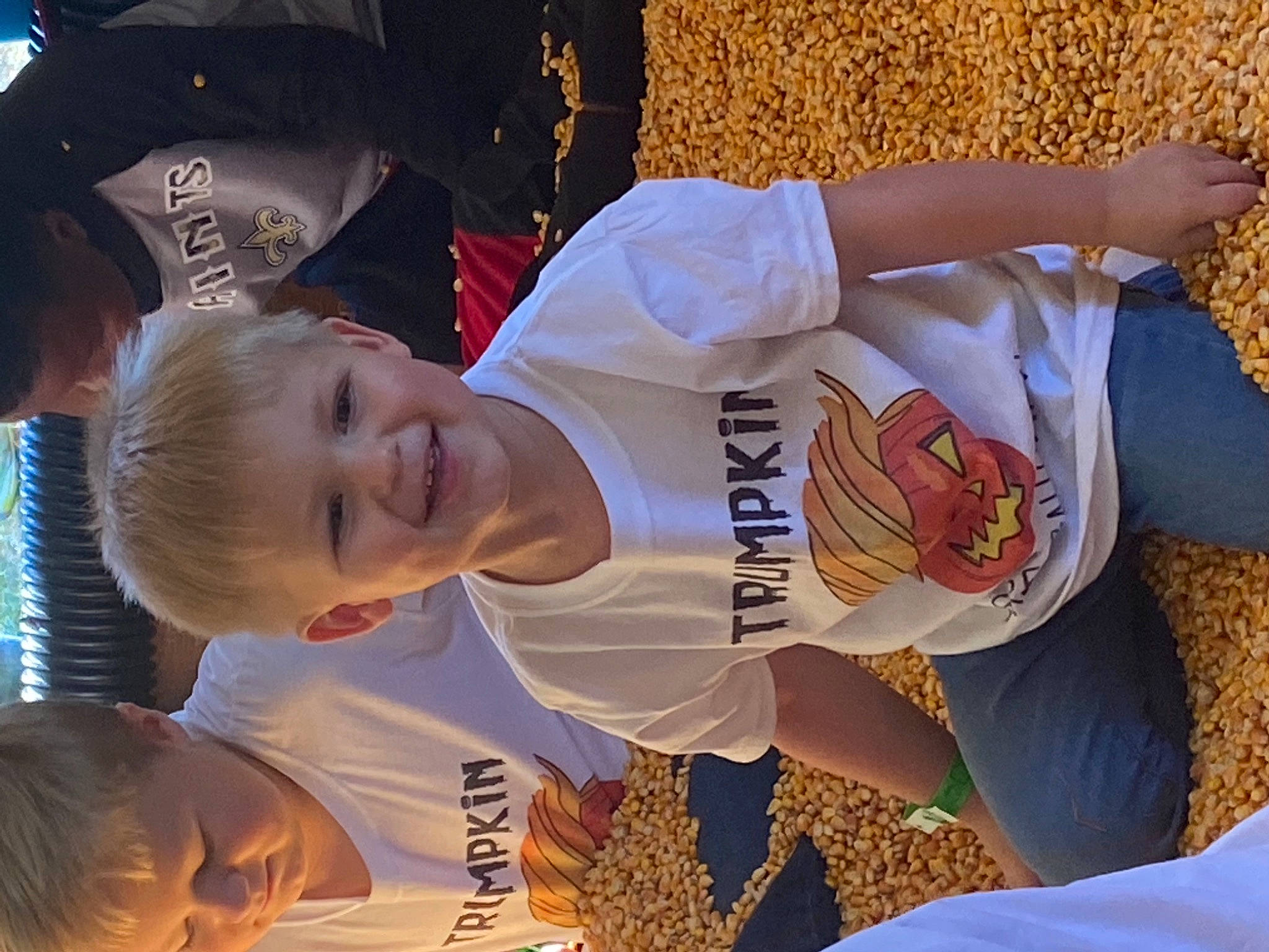 Wesson is registered to the contest to win money with this photo: elbow, event, fun, gesture, happy, jersey, joy, light, mammal, orange, person, photograph, player, sleeve, smile, sports_uniform, t_shirt, thigh, toddler, under_exposed