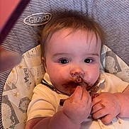 Theo joined the competition — help win amazing prizes! baby, child, chocolate, messy, high_chair, face, hands, eating, food, cute, infant, clothing, indoor, portrait, closeup, person, feeding, expression, seat, graco