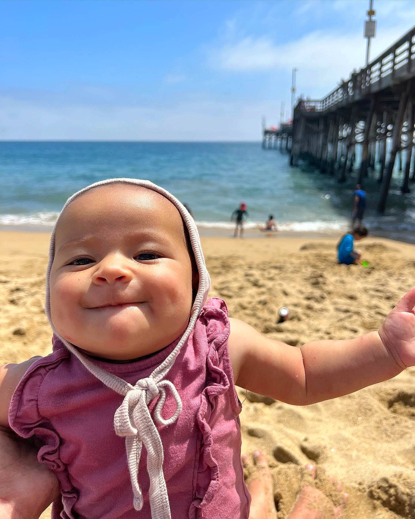 Aliyah joined the competition — help win amazing prizes! azure, beach, cloud, coastal_and_oceanic_landforms, finger, fun, gesture, hand, happy, horizon, joy, leisure, people_in_nature, people_on_beach, person, sky, smile, summer, thumb, toddler