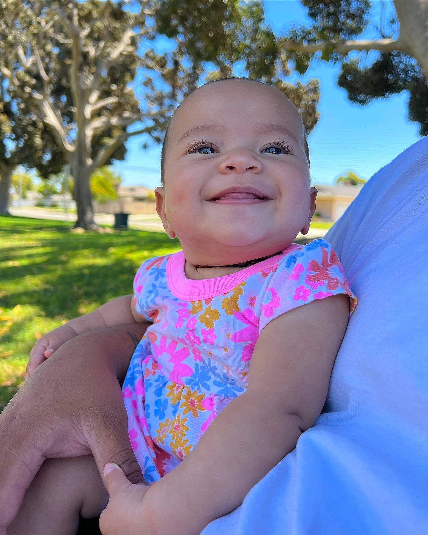 Aliyah is registered to the contest to win money with this photo: arm, azure, baby, baby_toddler_clothing, dress, eye, finger, gesture, happy, iris, joy, leaf, people_in_nature, person, pink, plant, shoulder, skin, sky, smile