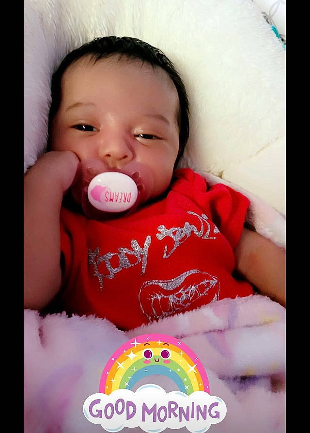 Amiah is registered to the contest to win money with this photo: arm, baby, baby_sleeping, baby_toddler_clothing, cheek, comfort, drinkware, face, facial_expression, finger, gesture, happy, lip, mouth, nose, person, pink, product, skin, sleeve