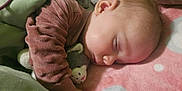 Juniper joined the competition — help win amazing prizes! apparel, baby, blanket, child, comfort, cozy, cute, face, green, hand, indoors, infant, peaceful, pink, plush_toy, portrait, resting, sleeping, soft, toddler