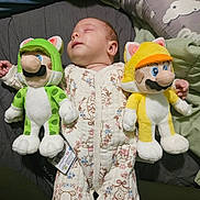 Juniper is registered to the contest to win money with this photo: baby, bed, blanket, cat_costume, child, cozy, cute, indoor, infant, mario, onesie, person, pillow, plush_toy, rest, sleep, sleeping, soft_toy, toy, winnie_the_pooh
