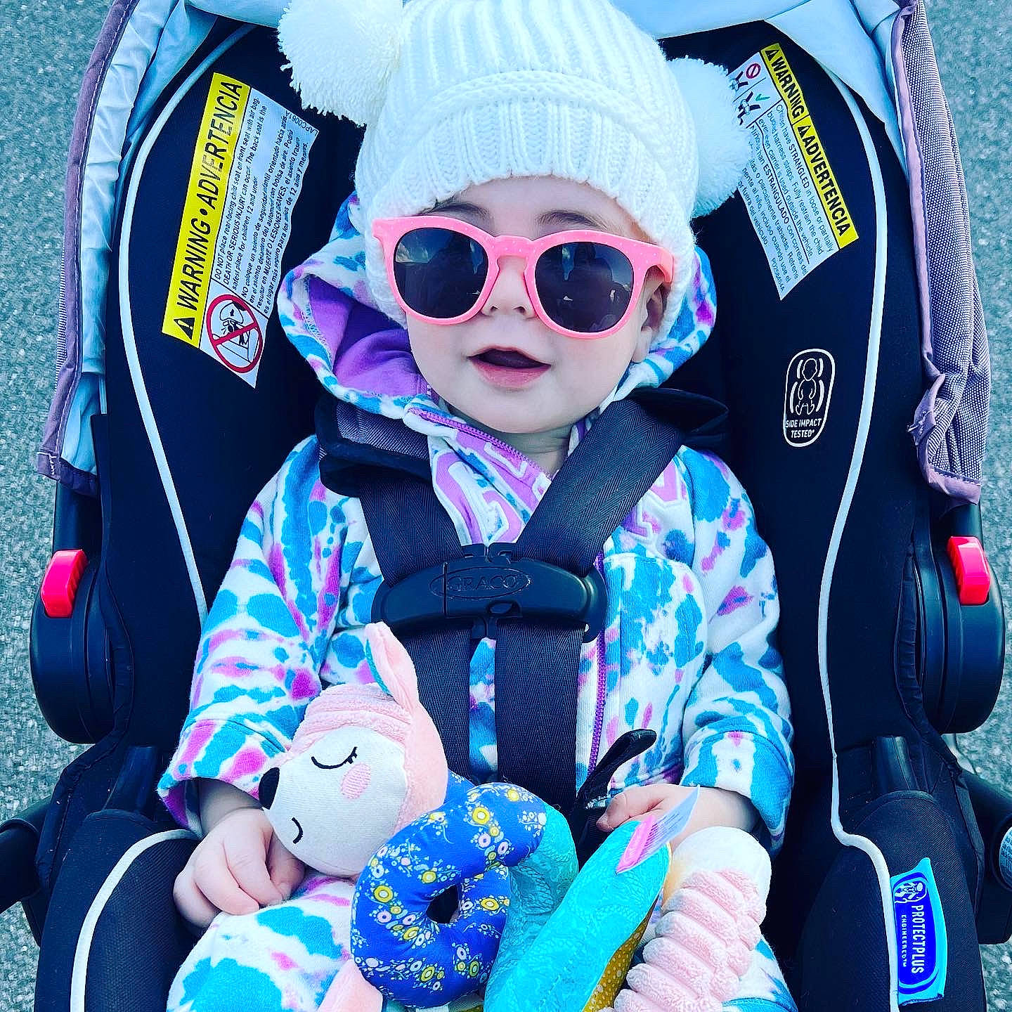 Aubree is registered to the contest to win money with this photo: baby, baby_toddler_clothing, blue, cap, cool, electric_blue, eyewear, fun, goggles, headgear, headwear, jacket, outerwear, person, personal_protective_equipment, pink, purple, sleeve, sunglasses, toddler