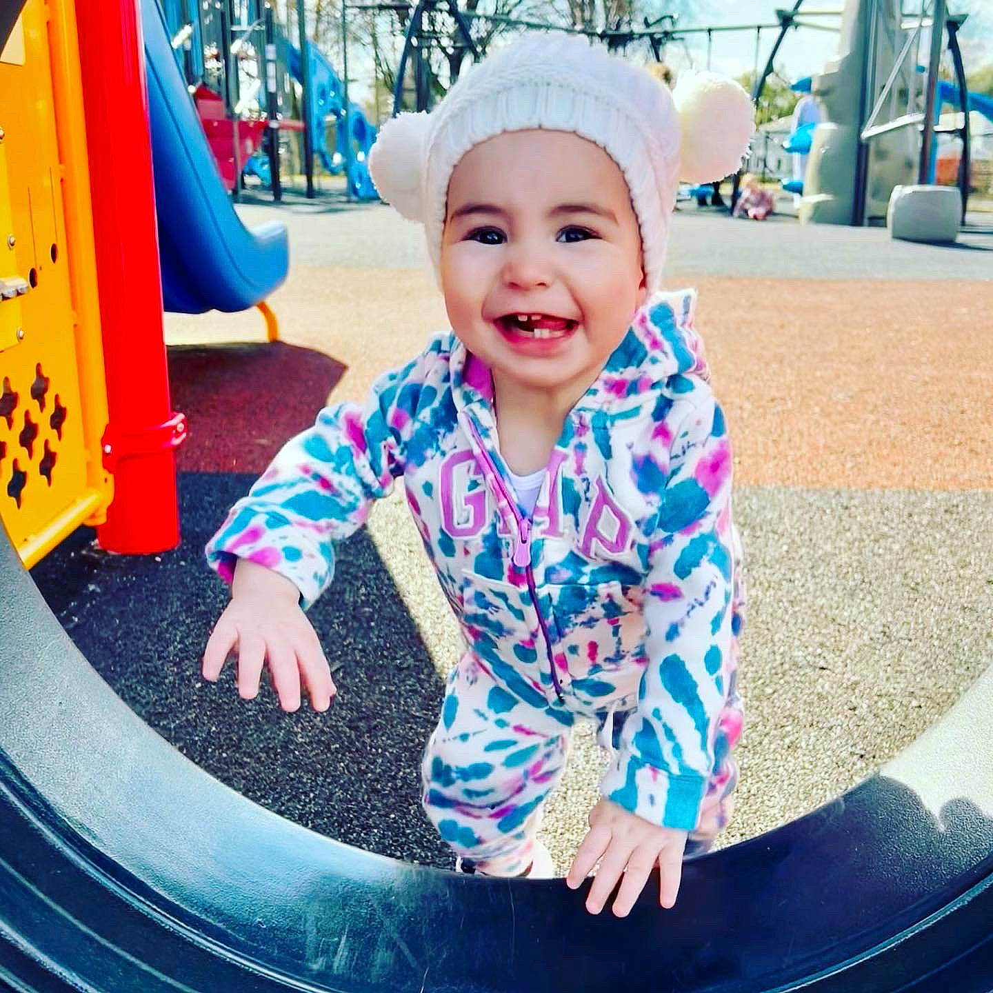 Aubree is registered to the contest to win money with this photo: baby_toddler_clothing, blue, cap, child, city, cool, facial_expression, fun, green, happy, hat, headwear, joy, leisure, person, photograph, playground, sleeve, smile, t_shirt