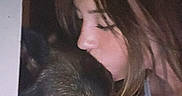 Molly is registered to the contest to win money with this photo: woman, dog, german_shepherd, affection, kiss, pet, animal, face, portrait, closeup, indoor, dark, love, bond, companion, friendship, head, human, calm, intimate