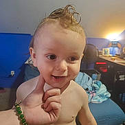 Huxon is registered to the contest to win money with this photo: baby, blanket, blue_wall, chair, child, clothing, cute, desk, expression, face, hair, hand, indoor, light, person, portrait, room, skin, smiling, toddler