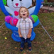 Huxon is registered to the contest to win money with this photo: toddler, child, inflatable, easter_bunny, easter_eggs, grass, leaves, outdoor, smiling, plaid_shirt, jeans, shoes, spring, holiday, festive, garden, flowers, decoration, playful, person