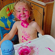 Huxon joined the competition — help win amazing prizes! blond_hair, child, colorful, cute, face_paint, food_mess, fun, happy, high_chair, indoor, kitchen, messy, pink_food, playful, sippy_cup, smiling, spoon, toddler, tray, wooden_cabinet