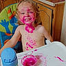 blond_hair, child, colorful, cute, face_paint, food_mess, fun, happy, high_chair, indoor, kitchen, messy, pink_food, playful, sippy_cup, smiling, spoon, toddler, tray, wooden_cabinet