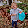 blue_bucket, bucket, child, daylight, decoration, grass, happy, jeans, leaves, nature, number_eight, outdoor, person, plaid_shirt, plant, shoes, smile, toddler, tree, wreath