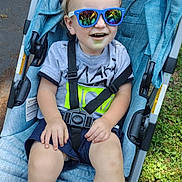 Huxon joined the competition — help win amazing prizes! baby, casual, child, feet, grass, happy, nature, outdoor, person, reflection, seatbelt, shirt, shorts, smile, socks, stroller, summer, sunglasses, sunlight, toddler