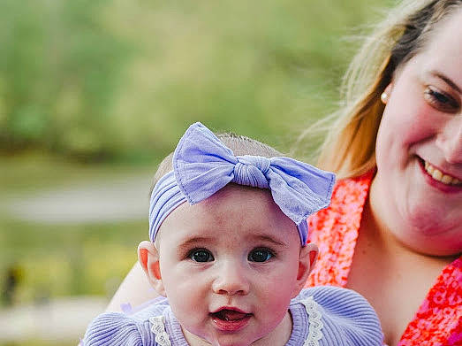Madelyn is registered to the contest to win money with this photo: baby, blond, close_up, electric_blue, eye, face, gesture, grass, happy, head, headwear, iris, joy, leisure, lip, people_in_nature, person, plant, recreation, skin