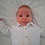 baby, infant, child, face, eyes, white_shirt, buttons, collar, blanket, bedding, lying_down, portrait, looking_at_camera, cute, newborn, skin, hands, bed, closeup, smile