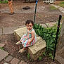Lydia Altamirano joined the competition — help win amazing prizes! toddler, child, outdoor, garden, stone_block, striped_dress, curly_hair, greenery, picnic_table, person, pathway, plant, sandals, serious_expression, daylight, nature, casual, playground, young_child, sitting