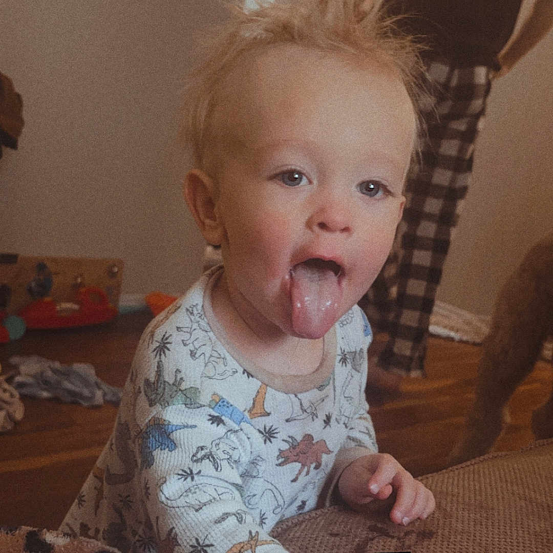 Waylon Ray joined the competition — help win amazing prizes! adult, baby, bodypart, clothing, couch, cushion, face, female, finger, furniture, hand, head, indoors, mouth, person, photography, portrait, t_shirt, tongue, woman