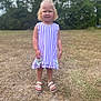 Nyomi is registered to the contest to win money with this photo: child, girl, curly_hair, dress, purple, white_sandals, outdoor, grass, trees, smile, standing, summer, nature, portrait, young, sunny, barefoot, person, happy, casual