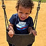 child, toddler, swing, playground, curly_hair, smiling, nike, tshirt, outdoor, sand, sunny, happy, person, play, fun, metal_chains, clothing, face, hands, seat