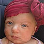 baby, infant, face, headwrap, bow, pink_clothing, blue_eyes, close_up, portrait, child, cute, skin, expression, headgear, newborn, young_child, soft_light, indoors, baby_girl, fashion_accessory