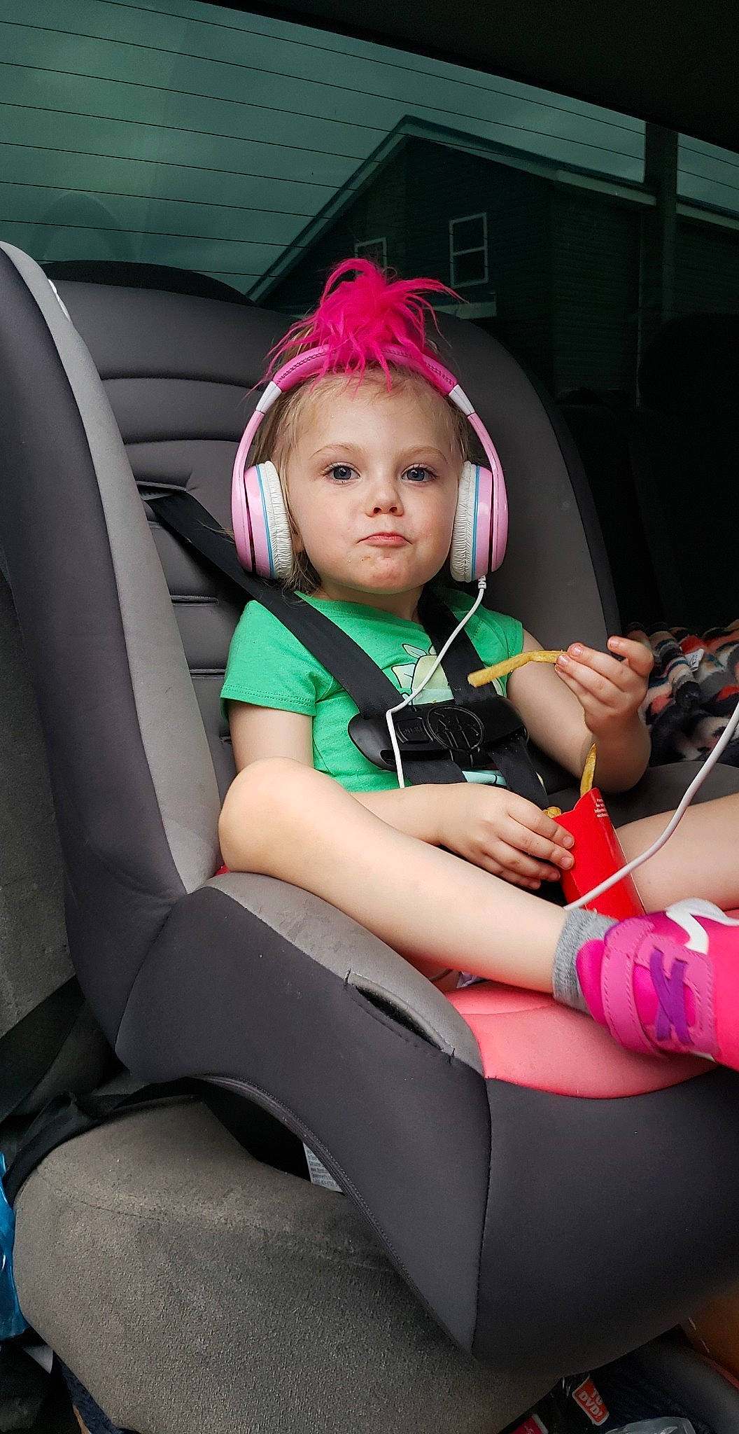 Sariah is registered to the contest to win money with this photo: arm, auto_part, automotive_design, car_seat, chair, comfort, dress, face, fun, hand, human_body, leisure, magenta, person, pink, plant, skin, steering_wheel, thigh, toddler