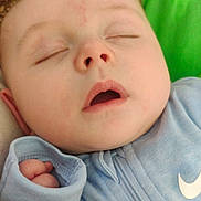 Jonathon is registered to the contest to win money with this photo: baby, sleeping, face, hat, blue_clothing, hand, infant, closeup, peaceful, cute, child, soft, knitted, nap, portrait, resting, indoors, young, toddler, cozy