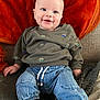 Hunter joined the competition — help win amazing prizes! baby, child, smiling, sitting, sweater, denim_pants, cozy, blanket, cushion, indoors, happy, cute, infant, portrait, clothing, furniture, person, young_child, casual, comfort