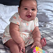 Ashly is registered to the contest to win money with this photo: adorable, baby, bed, blanket, child, chubby, clothing, cute, face, hair, happy, indoors, infant, pink, playful, sitting, skin, smiling, toy, young