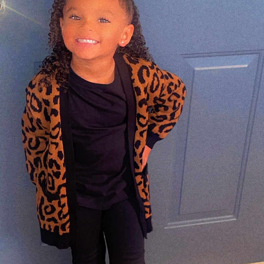 Malasia joined the competition — help win amazing prizes! accessories, blazer, child, clothing, coat, door, face, female, footwear, girl, hardwood, head, jacket, pants, person, photography, portrait, purple, shoe, wood