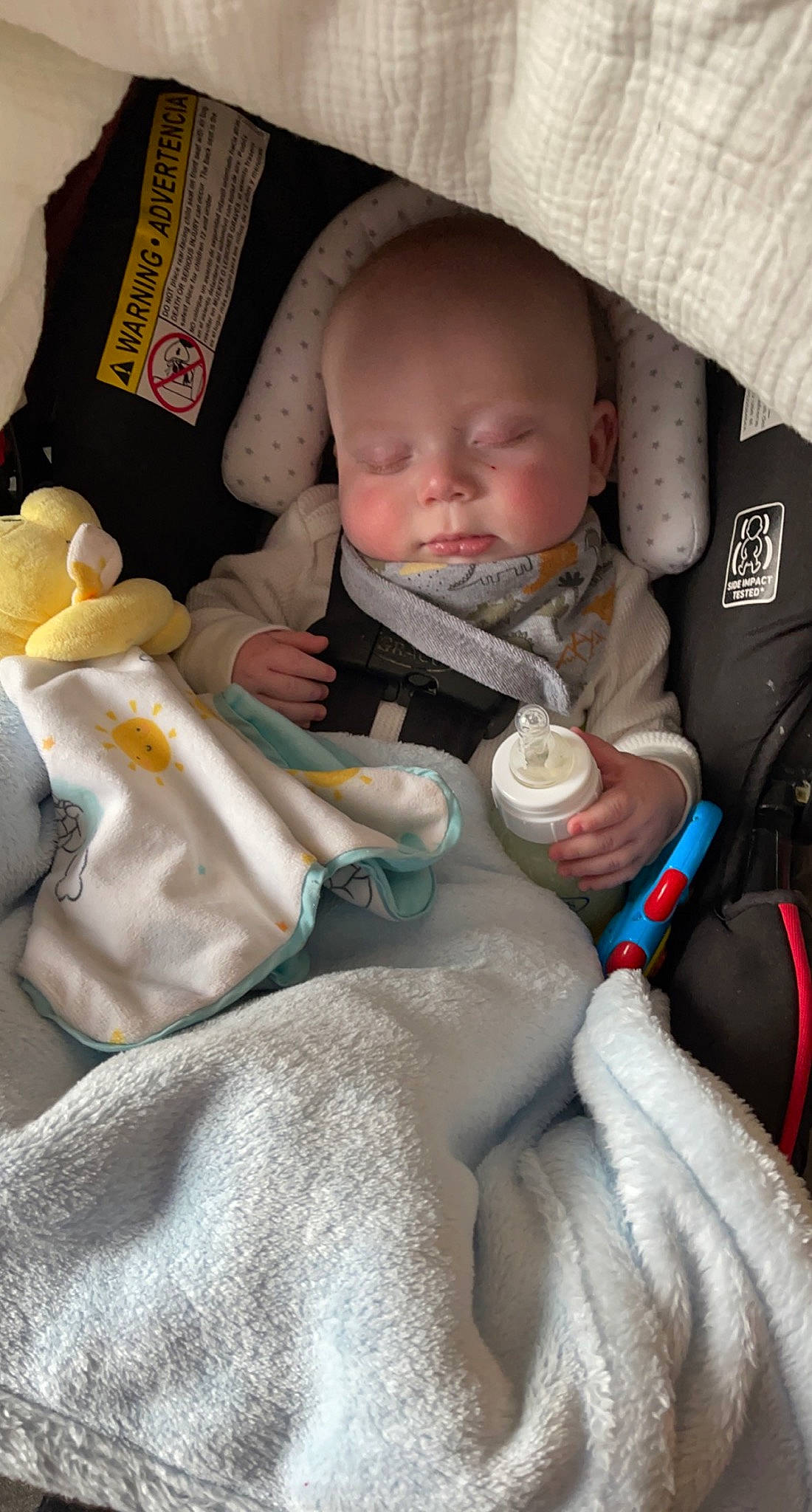 Morgan is registered to the contest to win money with this photo: arm, baby, baby_carriage, baby_in_car_seat, cheek, comfort, finger, hand, head, human_body, lap, mammal, mouth, nose, organ, person, product, seat_belt, skin, textile